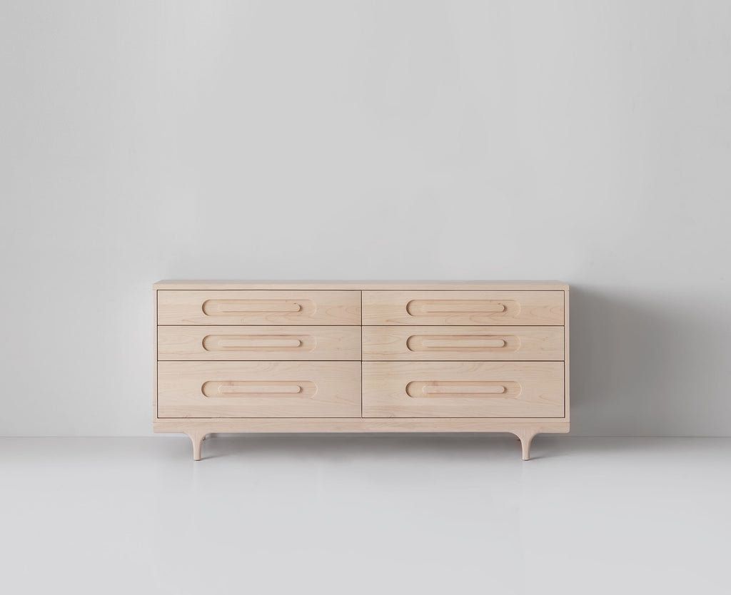 Caravan Double Dresser in ash, centered front view on a white studio floor, six drawers with oblong recessed pulls.
