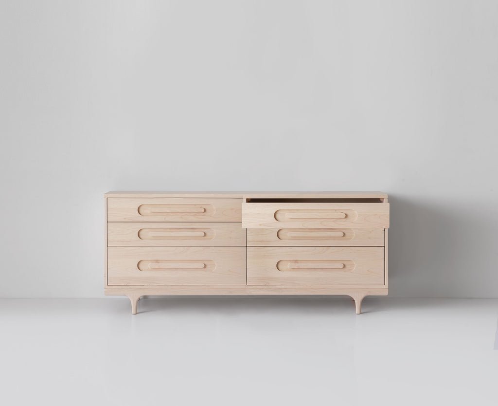 Caravan Double Dresser in ash with the top-right small drawer pulled out, six drawers total on a white studio floor.