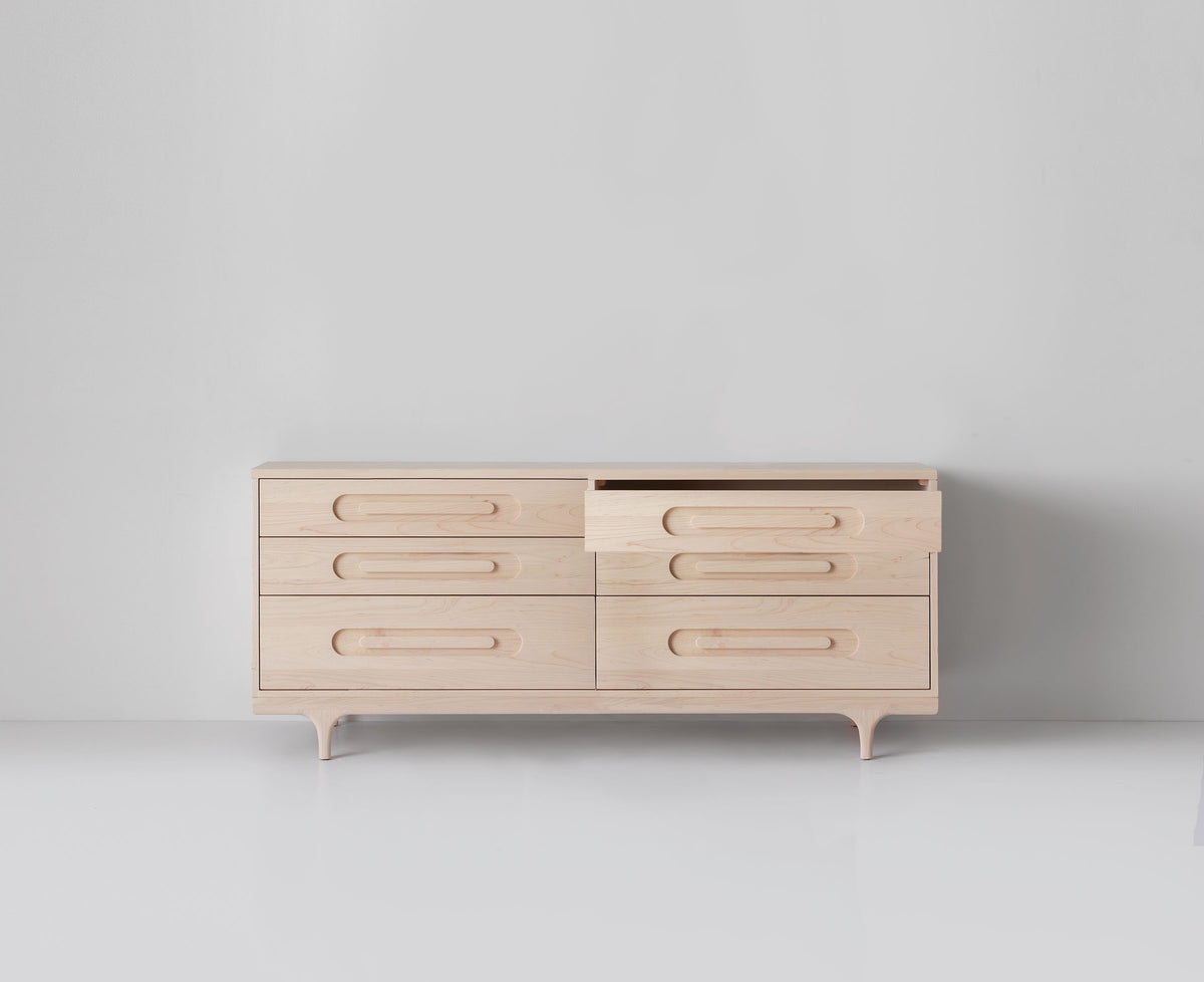 Caravan Double Dresser in ash with the top-right small drawer pulled out, six drawers total on a white studio floor.