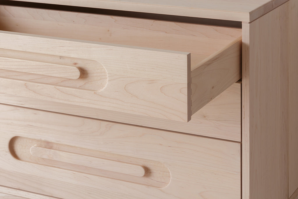 Caravan Dresser in ash with the top drawer fully pulled out, showing the dovetail joinery at the corner of the drawer box.