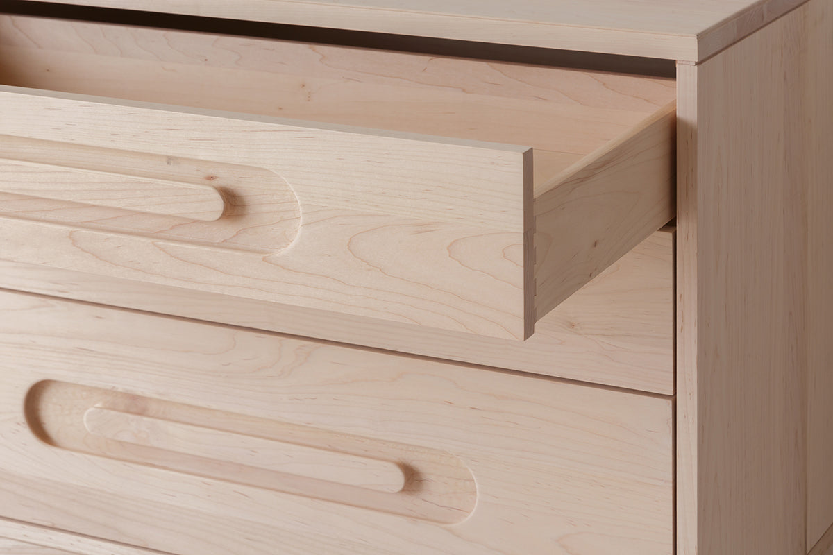 Caravan Dresser in ash with the top drawer fully pulled out, showing the dovetail joinery at the corner of the drawer box.