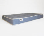 Dream Mattress in blue linen with cream piping along the edges, channel-quilted top, Kalon label visible on the side.