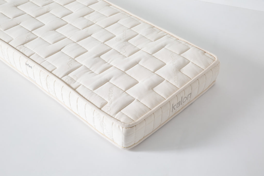 Dream No. 1 Mattress top-down corner view with rectangular grid tufting and Kalon branding stitched on the side ticking.