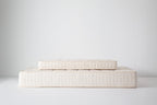 Kalon Organic Mattress with a smaller Dream No. 1 crib mattress stacked on top, showing the range of available sizes.