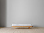 Caravan Crib in white oak with walnut caps, platform toddler bed conversion on a maple plank floor, all rails removed.
