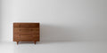 Caravan Dresser in solid walnut, off-center to the left in a wide format frame on a white studio floor, hero composition.