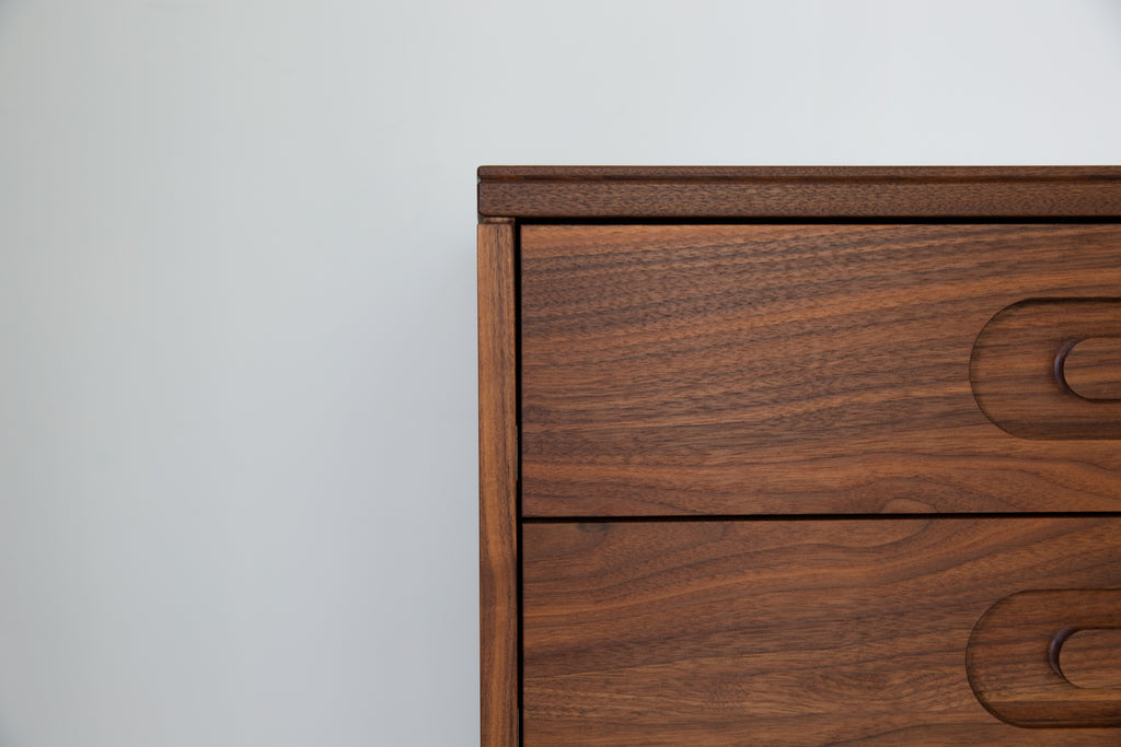Caravan Double Dresser top corner detail in walnut, figured grain on the top edge and right column drawer fronts visible.