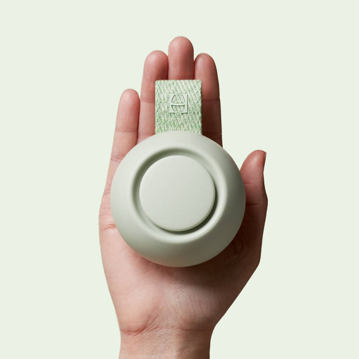 Hand holding a Hatch Go portable sound machine