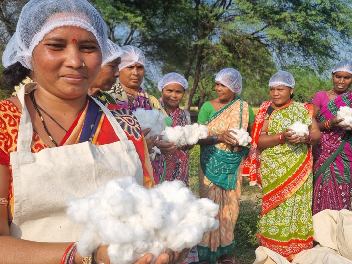 Cotton farmers in India holding freshly picked organic cotton
