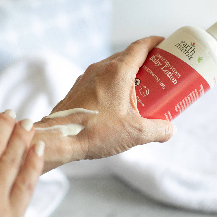 Hand applying Earth Mama Simply Non-Scents Baby Lotion