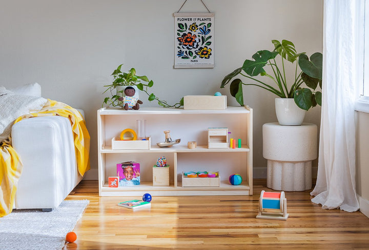 Lovevery Montessori Playshelf styled with toys and books in a sunny living room