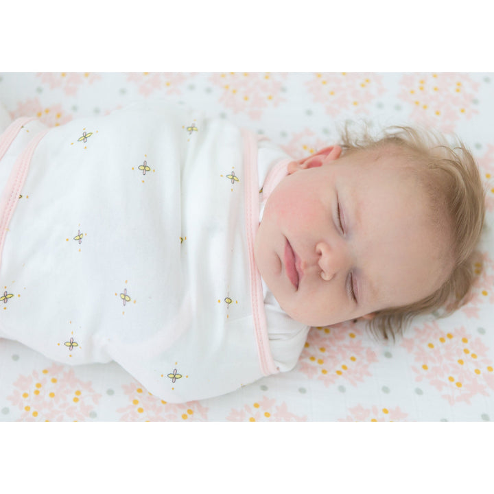 Baby asleep in a SwaddleDesigns Omni Swaddle Sack