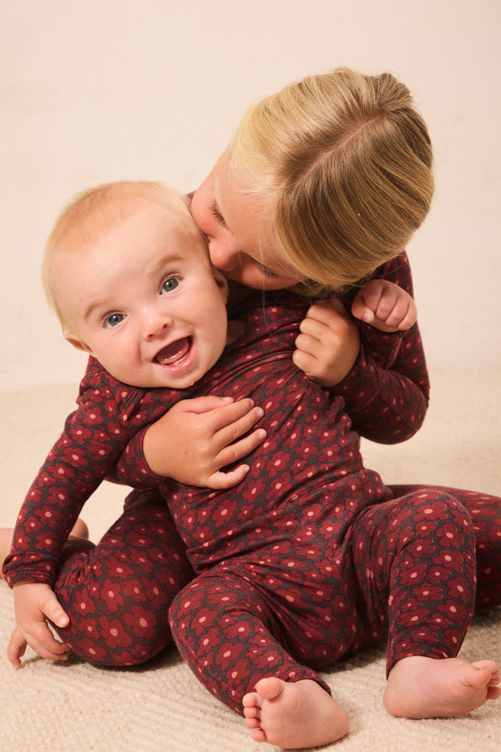 Mother cuddling a laughing baby in a Solly Baby sleep set