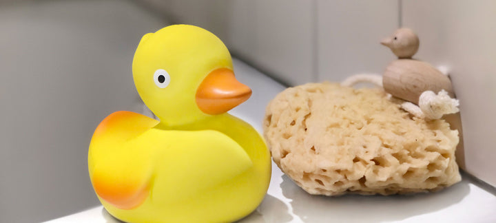 CaaOcho natural rubber duck beside a sea sponge