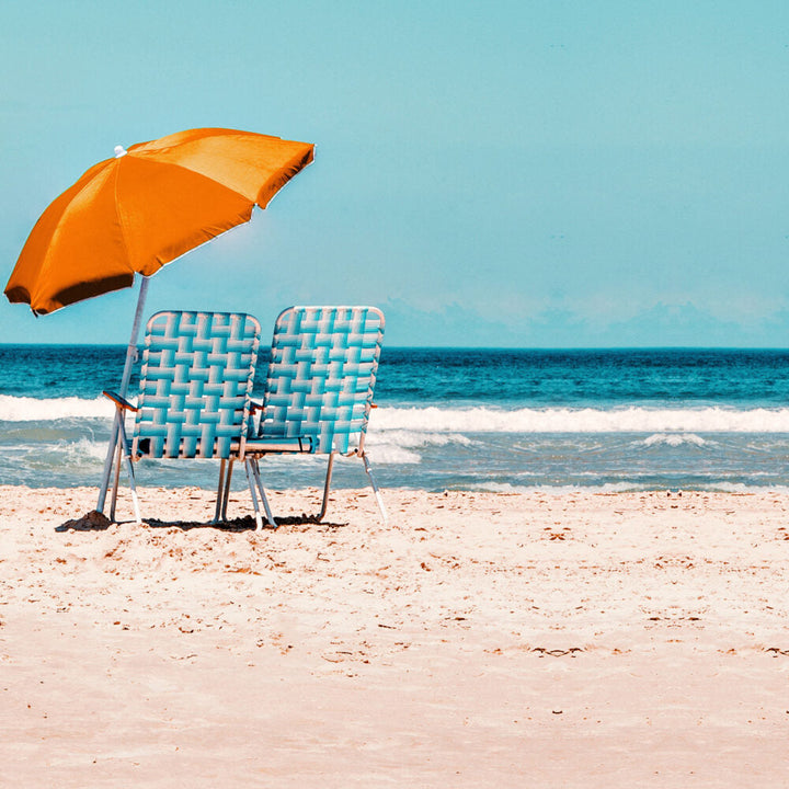 Beach chairs and an umbrella by the sea