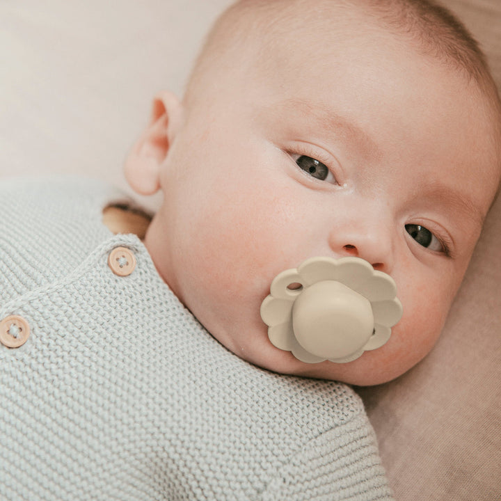 Baby with a Suavinex flower-shaped pacifier