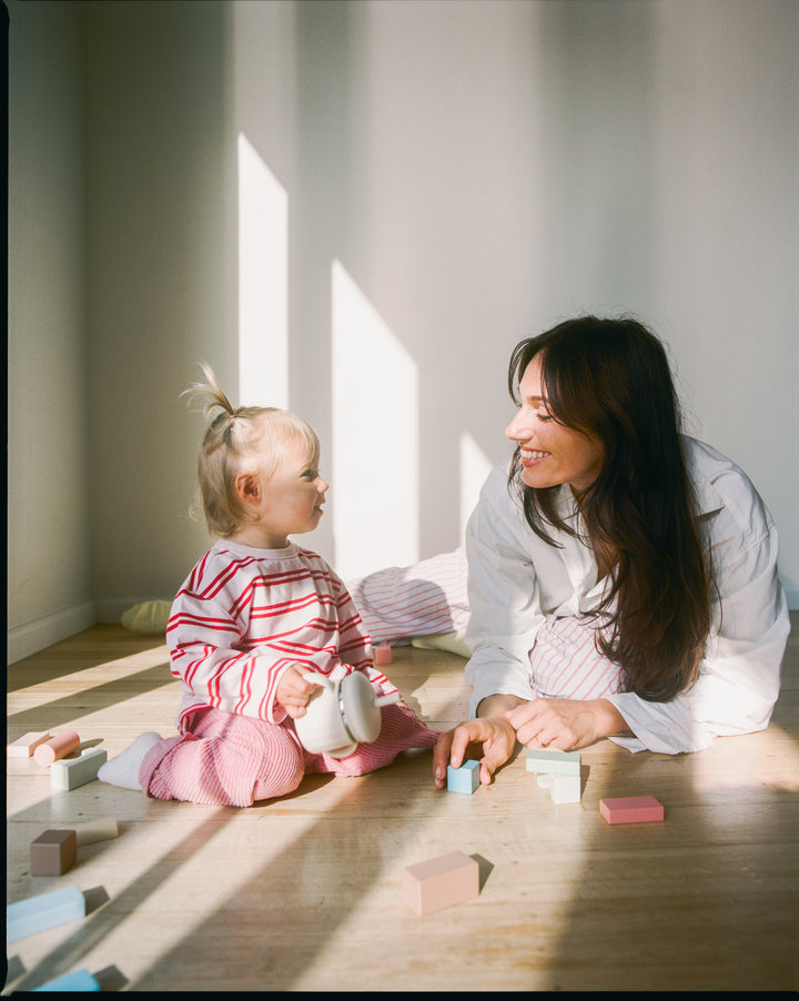 Mother playing with her toddler on the floor