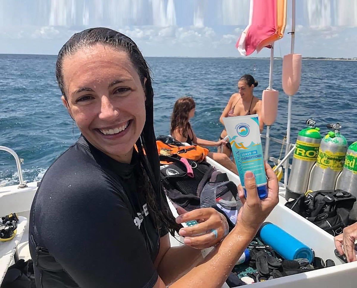 Woman on a dive boat holding a Stream2Sea product