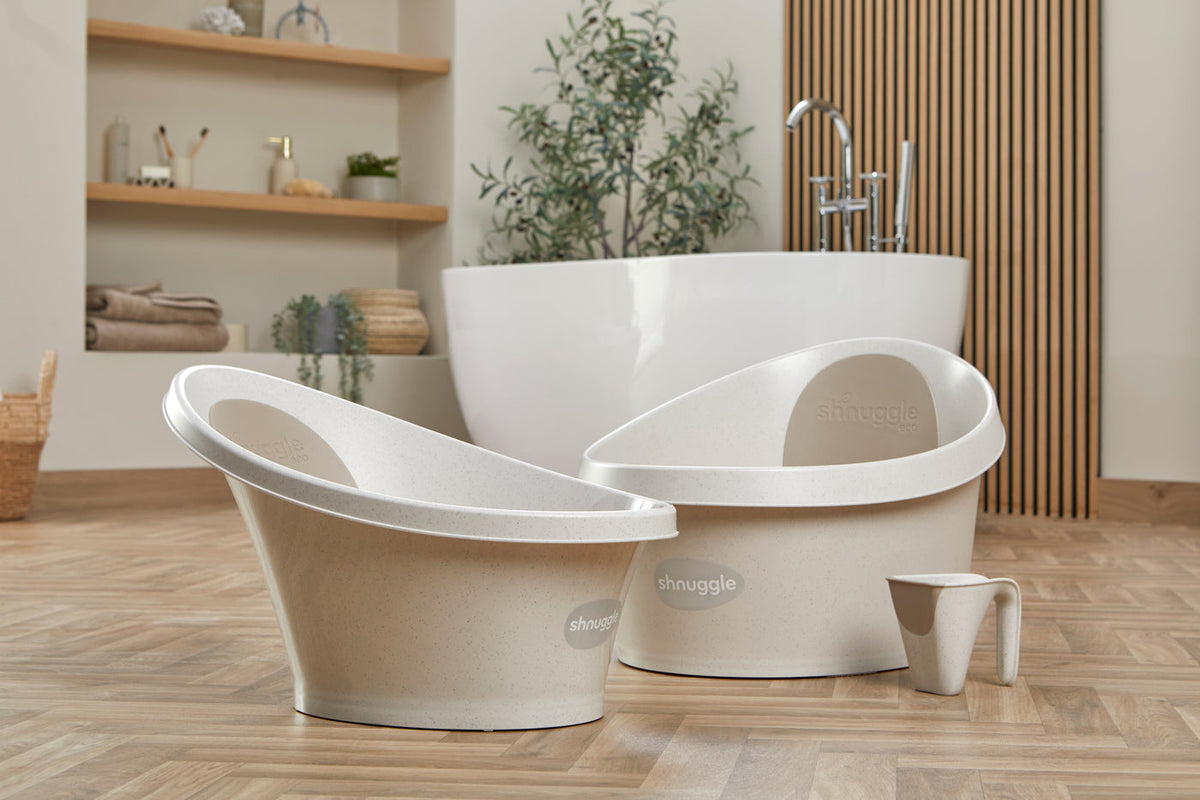 Two Shnuggle baby baths and a rinse jug in a bathroom