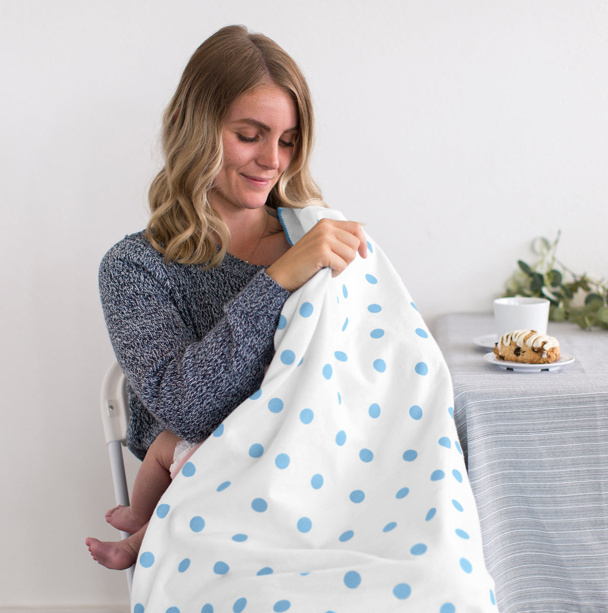Mother holding a baby wrapped in a SwaddleDesigns Ultimate Swaddle Blanket