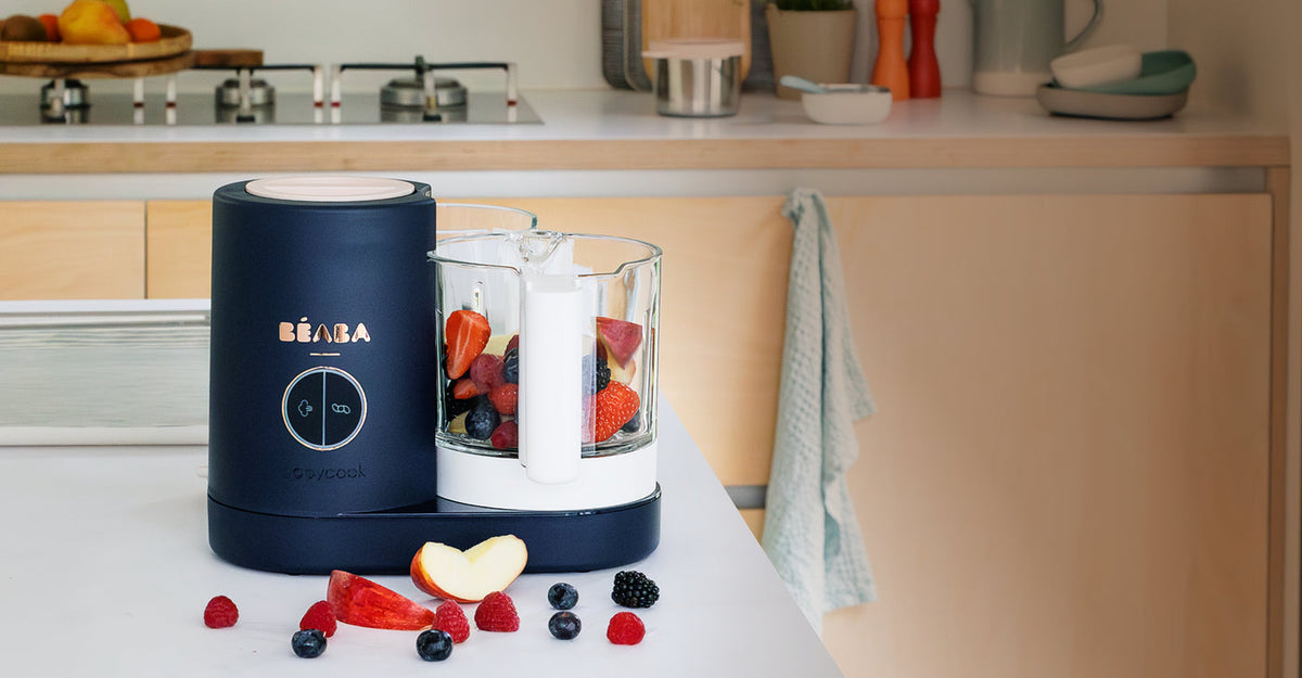BÉABA Babycook baby food maker filled with fruit on a kitchen counter