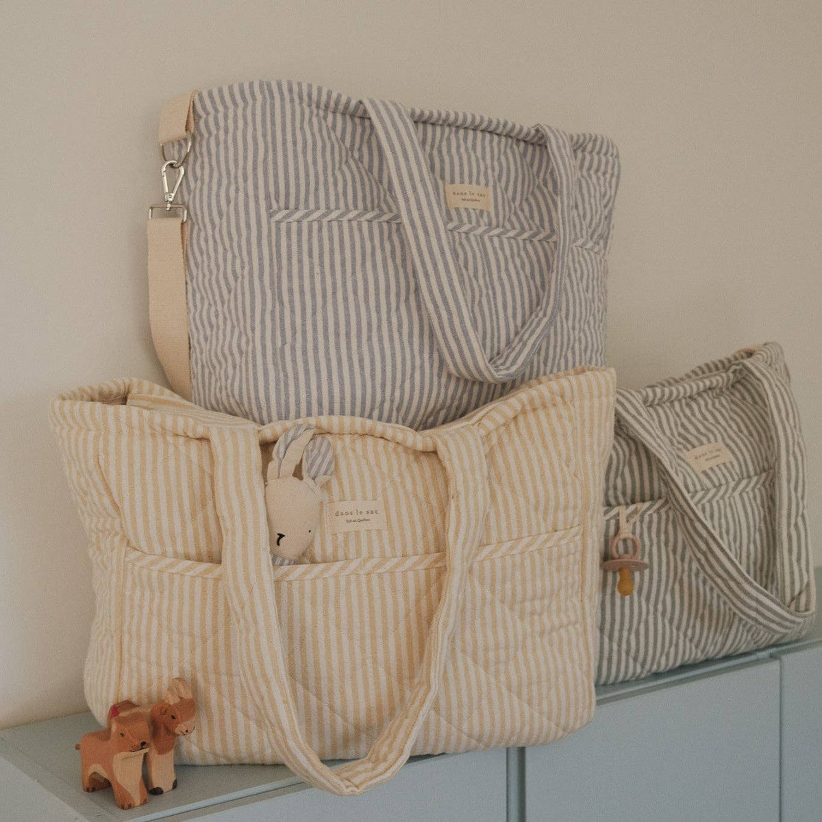 Stack of Dans le sac quilted striped diaper bags