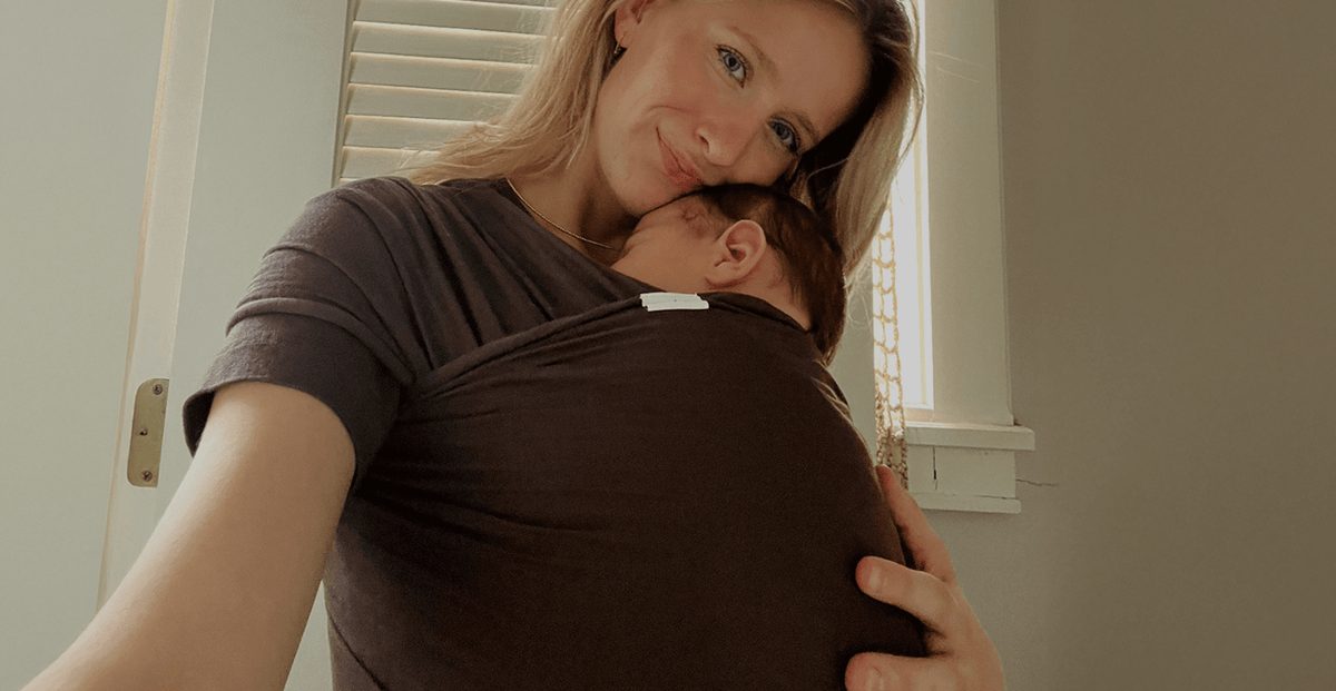 Mother wearing her newborn in a Solly Baby wrap