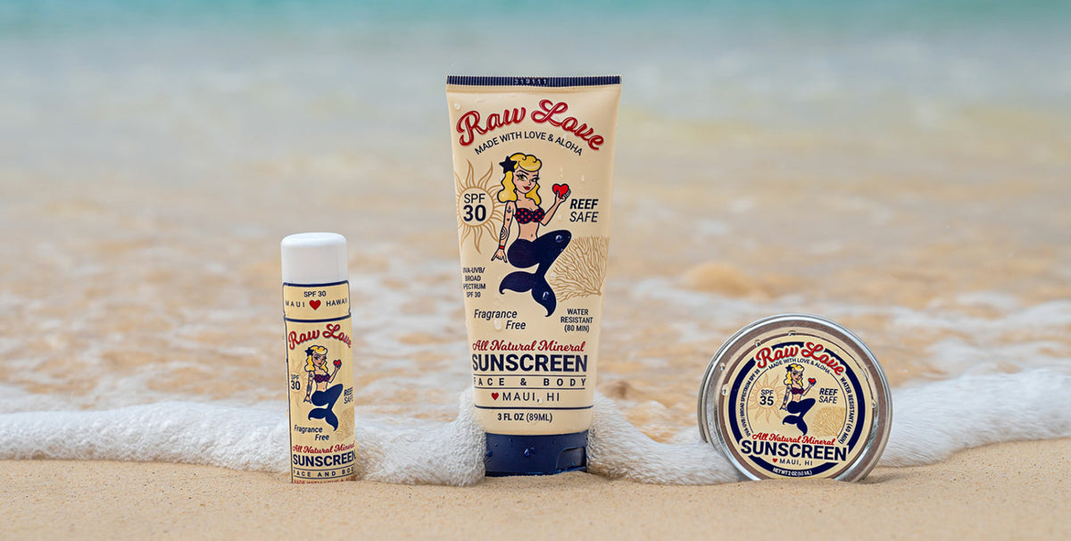 Raw Love mineral sunscreen tube, stick and tin in the surf on a beach