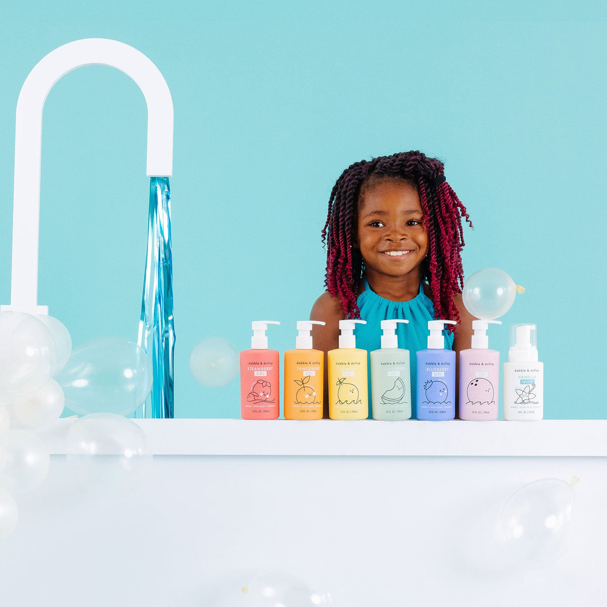 Girl behind a row of Dabble & Dollop bath gift set bottles
