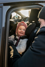Child in the Axkid ONE 3 with the car door open
