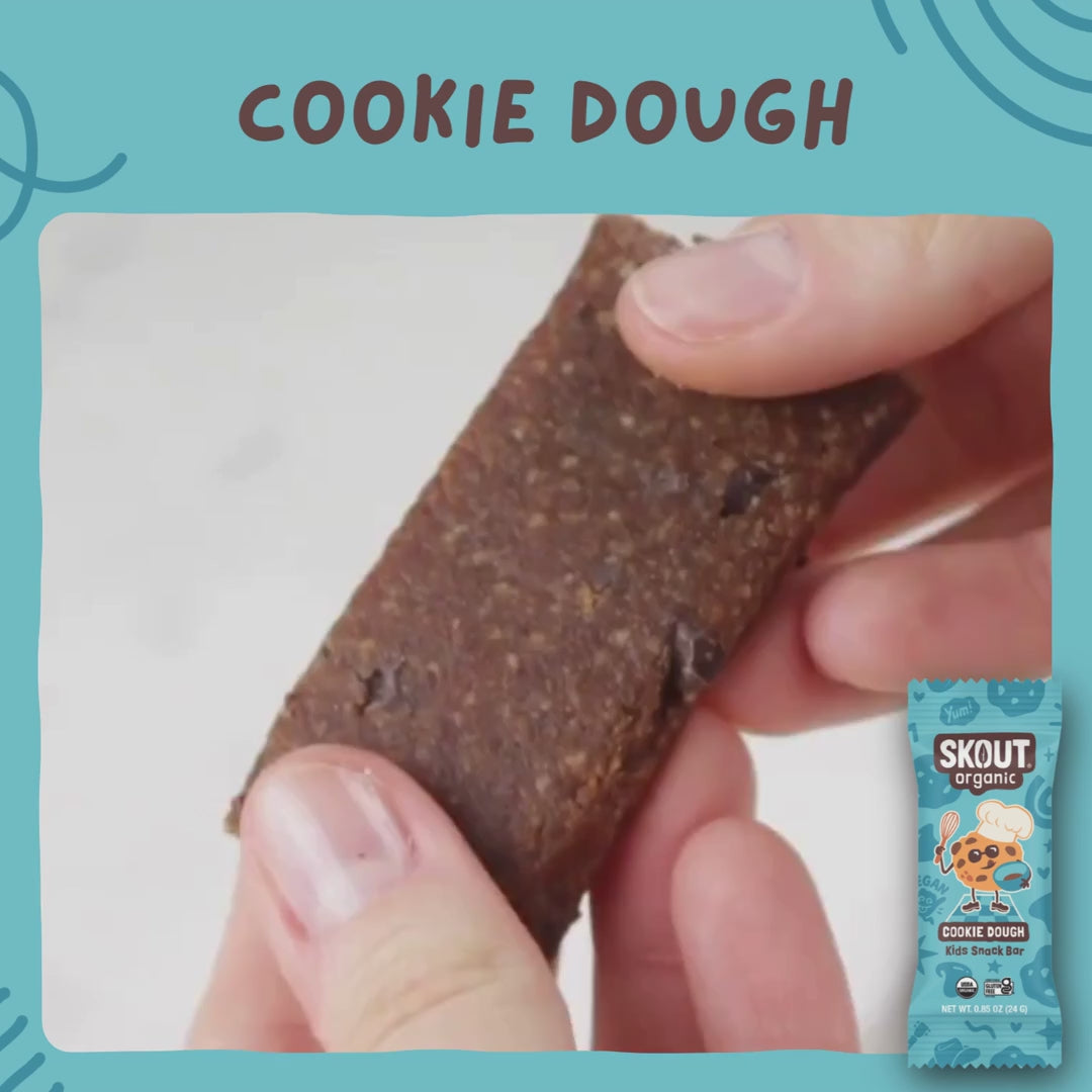 Skout Organic Cookie Dough Kids Bar - Close-up of a Cookie Dough Kids Snack Bar being pulled apart to show its soft, chewy interior with chocolate chip pieces.